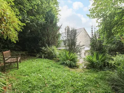 a bench in the yard of a house at Tinners Cottage in Saint Cleer