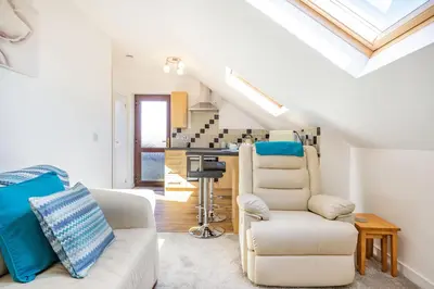 a living room with a couch and a chair at The Litte Hideaway in Saint Columb Minor