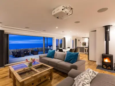 a living room with a view of the ocean at Boscarne in St Ives