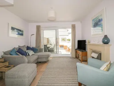 a living room with a couch and a fireplace at 5 Ocean Heights in Newquay