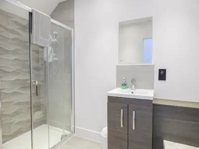 a bathroom with a shower and a sink at 5 Ocean Heights in Newquay
