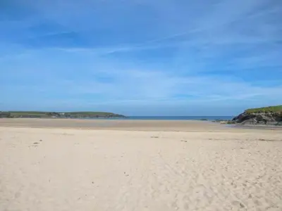 a sandy beach with the ocean in the background at 7 Harlyn Cottages in St Merryn