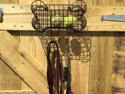 a basket of tennis balls on a wooden wall at 7 Harlyn Cottages in St Merryn