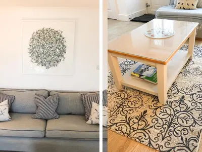 a living room with a couch and a table at 7 Harlyn Cottages in St Merryn