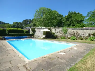 a large blue swimming pool in a yard at The Bullshed in Saint Erth