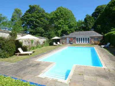 a swimming pool in the backyard of a house at Flower House in Saint Erth