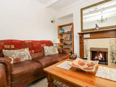 a living room with a couch and a fireplace at Angarrack Farmhouse in Hayle
