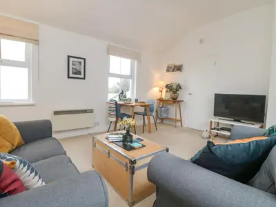 a living room with two couches and a television at Mackerel Sky in Marazion