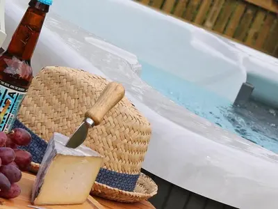 a cutting board with a knife and a basket of grapes at Omalast in Truro