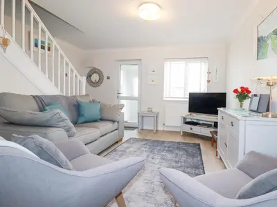 a living room with a couch and a tv at Gull Cottage in Padstow