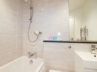 a bathroom with a shower and a tub and a sink at Gull Cottage in Padstow