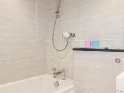 a bathroom with a shower and a bath tub at Gull Cottage in Padstow