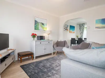 a living room with a couch and a tv at Gull Cottage in Padstow