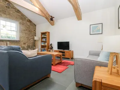 a living room with two couches and a tv at Wheal Grey in Germoe