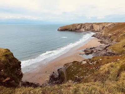 a view of the beach from a cliff at Kingfisher House in Tintagel