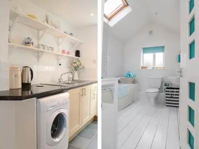 a white laundry room with a washer and dryer at Ner Sea in Marazion