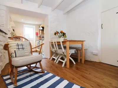 a kitchen and dining room with a table and chairs at Ner Sea in Marazion