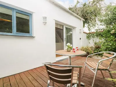 a patio with a table and chairs on a deck at Bolitho's Retreat in Saint Martins Green