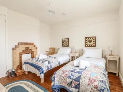 a bedroom with two beds and a fireplace at Bolenowe in Polzeath