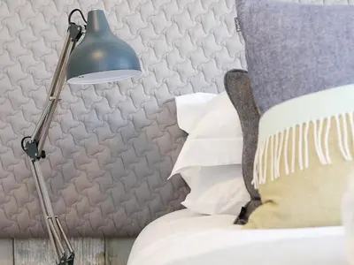 a bedroom with a bed with a lamp on it at Long House, Boskensoe Barns in Helford Passage