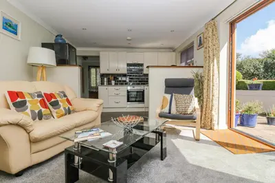 a living room with two couches and a glass table at Silverwell Forge in Chacewater