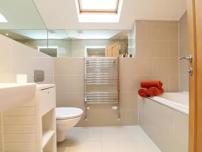 a bathroom with a toilet and a sink and a mirror at Chy Kerris, Carbis Bay in Carbis Bay