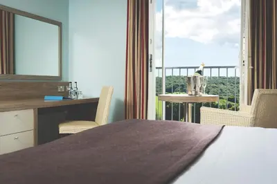a bedroom with a bed and a large window at County Arms in Truro