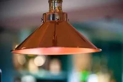 a brown light fixture hanging from a ceiling at County Arms in Truro