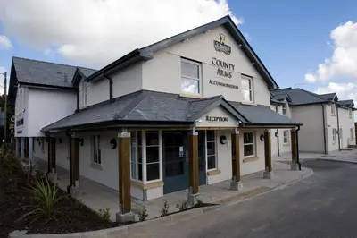 a white building with a black roof at County Arms in Truro