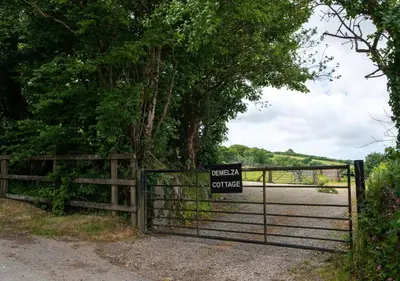 a gate with a sign that reads get a divorce at Demelza Cottage Apartment in Bodmin