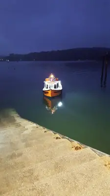 a boat sitting in the water at night at Polmarine in Polruan