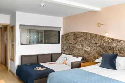 a hotel room with two beds and a couch at Bedruthan Hotel & Spa in Newquay