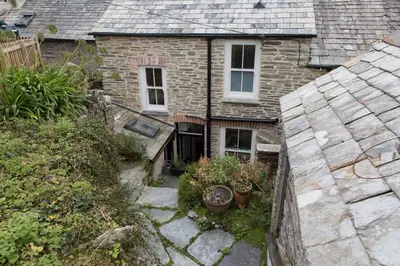 an aerial view of a brick house with potted plants at Fernleigh Cottage in Boscastle