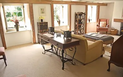 a living room with a couch and a table at Bonython Farmhouse in Cury
