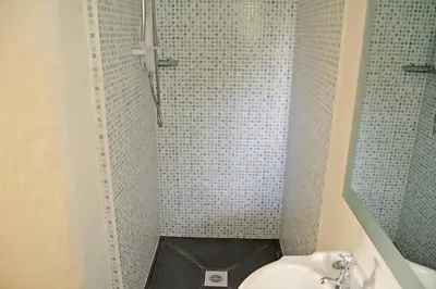 a bathroom with a shower with a toilet and a sink at Bonython Farmhouse in Cury
