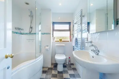 a bathroom with a sink and a toilet and a bath tub at Cargurra Park Farm in Boscastle