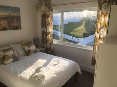 a bedroom with a bed with a mask on it at 34 Surfview Beach House in Newquay