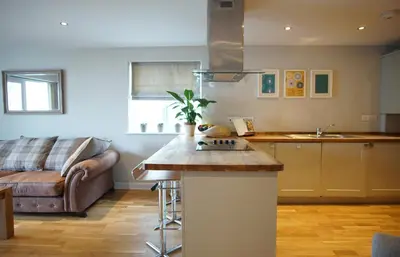 a kitchen and living room with a couch at Ocean Views 3 in Newquay