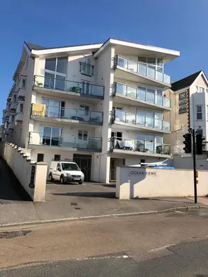 an apartment building with a car parked in front of it at Ocean Views 3 in Newquay