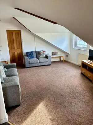 a living room with a couch and a table at The Haven in Portreath