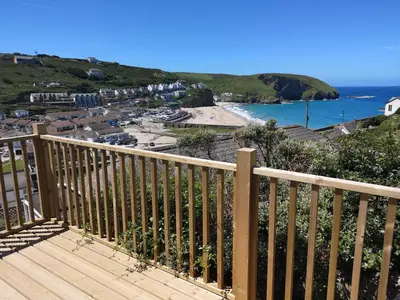 a wooden balcony with a view of the ocean at The Haven in Portreath
