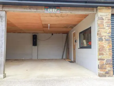 a garage with a sign that reads cosx at Cosy Cottage in Liskeard