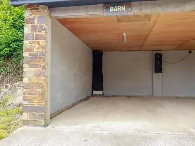 a garage with a sign that reads barn at Barn Cottage in Liskeard