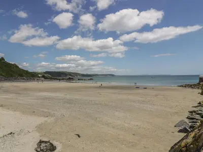 a view of a beach with people in the water at Barn Cottage in Liskeard