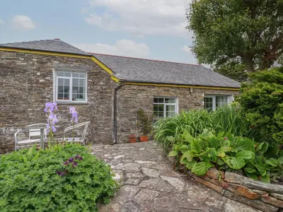 a brick house with a garden in front of it at The Garden Apartment in Tintagel