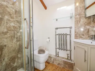a bathroom with a toilet and a sink at The Old Smithy in Saint Columb Major
