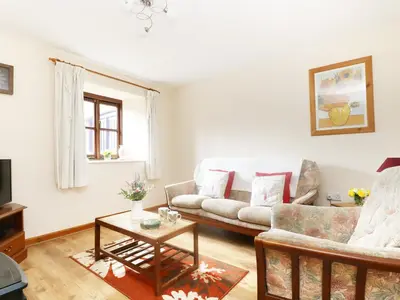 a living room with a couch and a table at The Old Granary in Launceston