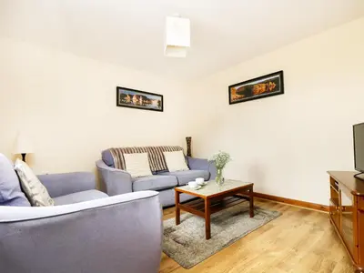 a living room with a couch and a table at The Shippon in Launceston