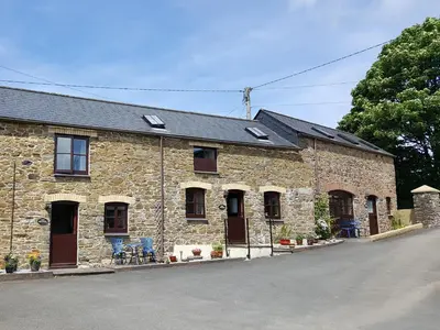 a stone building with windows and a roof at The Wagon House in Launceston