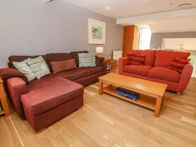 a living room with two couches and a coffee table at Beachcombers in Newquay